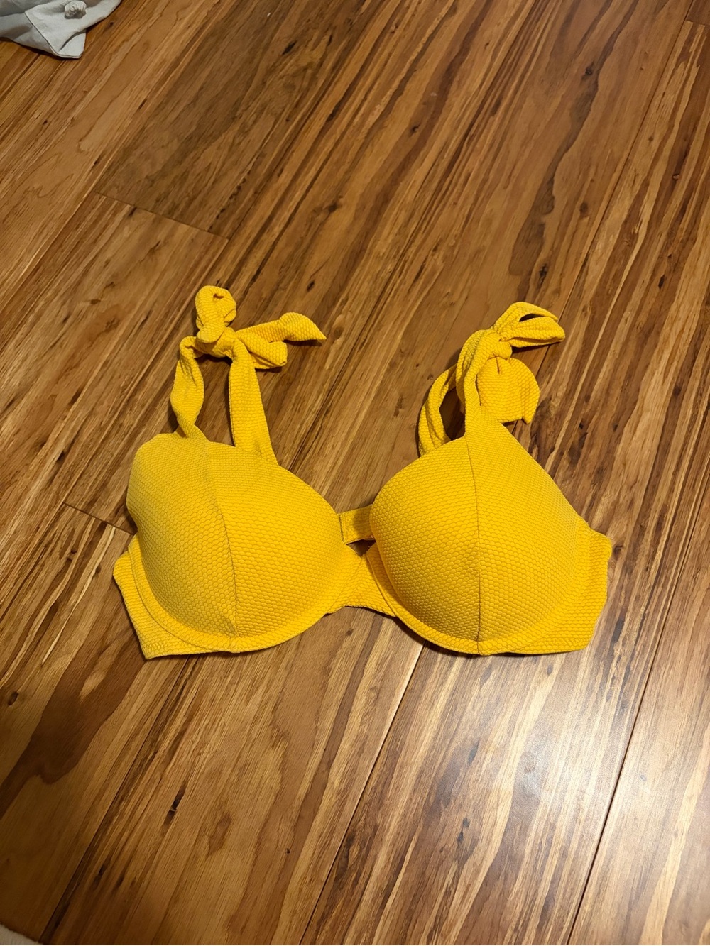 Yellow underwire bikini top with adjustable tie straps and a supportive fit.